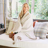 personalized pom pom blanket wrapped around on swing