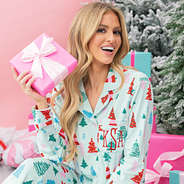 girl with present wearing mint wonderland personalized softspun pajamas