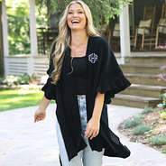 black monogrammed poncho cardigan front with denim