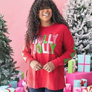 girl wearing crimson holly jolly sweatshirt