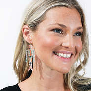 close up of girl wearing skeleton earrings