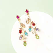 lights christmas earrings on marble dish