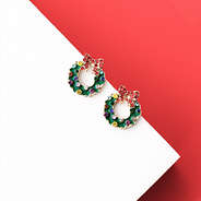close up of green wreath earrings