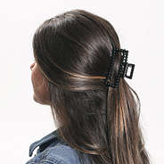 brunette wearing black beaded claw clip