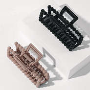 studio shot of mauve and black beaded claw clips