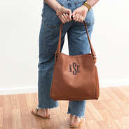 brown hobo purse in hands