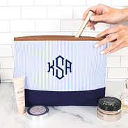 monogrammed seersucker cosmetic bag on marble counter