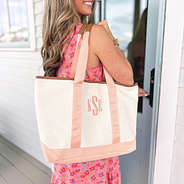 girl with monogrammed coral boat tote over shoulder