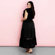 black midi skirt on Julia in front of pink paper