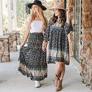 girls wearing midi skirt and puff sleeve dress in black paisley