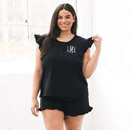 plus size model in black ruffle pajamas