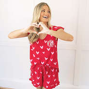 red hot hearts ruffle pajamas full set on girl with heart hands
