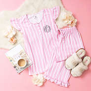 pink and white stripe ruffle pajamas flatlay