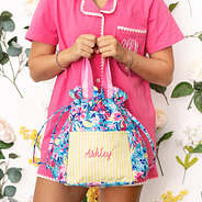 girl holding monogrammed watercolor whimsy toiletry bag