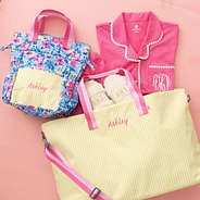 monogrammed toiletry bag in watercolor whimsy with monogrammed weekend bag in sunshine stripes