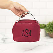 maroon makeup bag in hand