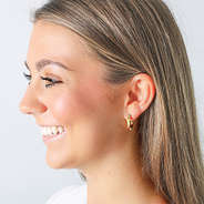 multi colored gold hoop earrings in ears