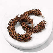 fringe hoop brown earrings on marble