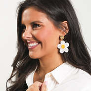 ivory flower earrings in ear