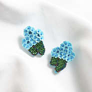 blue hydrangea earrings on white cloth
