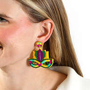 Mardi gras earrings in ear