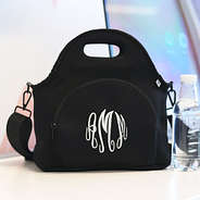 black neoprene lunch bag on desk