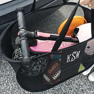 inside of black personalized pop up bag with kids outdoor toys