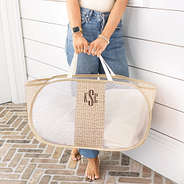 girl holding personalized laundry basket in khaki pebbles