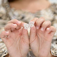 silver earrings in hands