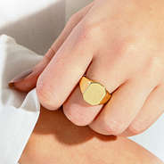 Signet ring on non ring finger detail shot