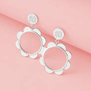silver scallop earrings on pink paper