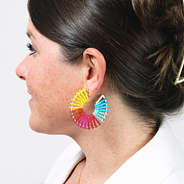 multi colored gold earrings in ears