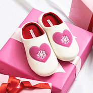 pink hearts slippers on top of gift box