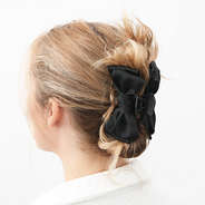black bow hair clip in hair