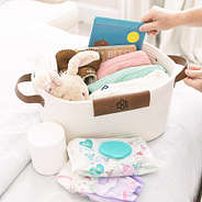 monogrammed white basket with baby and kids accessories