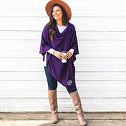 purple monogrammed poncho with riding boots and hat