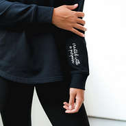 up close of black faith pullover