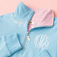 close up of embroidery on faith pullover in blue and pink seersucker