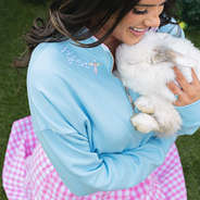close up of girl wearing risen easter blue faith pullover with bunny