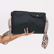 folded monogrammed storage bag in black in hands