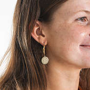 gold cable hoop earrings in ear