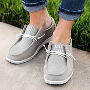 light gray slip on shoes on sidewalk