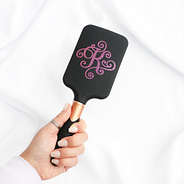 black hairbrush in hand