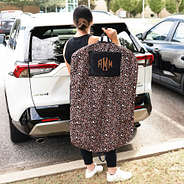 cheetah garment bag in hand