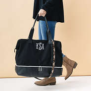 girl carrying monogrammed black mosaic canvas weekender