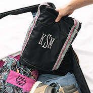 packable black spottie monogrammed weekender duffle in suitcase