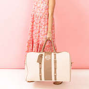 ivory weekender bag in hand with dress
