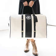 ivory/black weekender bag in hand