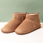 sherpa ankle booties on green and white background