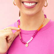 pink beaded necklace with puff sleeve sweatshirt